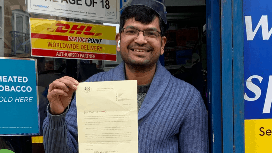 Vimal with his letter outside the shop on Gwent Court, Rotherhithe