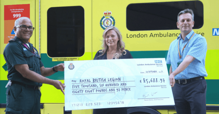 André (left) presenting a cheque to Sarah-Jane from the RBL alongside LAS Chief Executive Daniel Elkeles