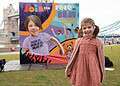 GOSH patient Sienna with completed TCS London Marathon mural featuring her portrait.