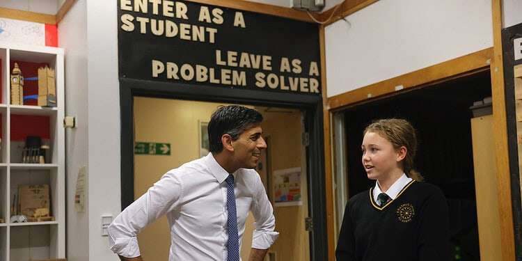 (pictured: Prime Minister Rishi Sunak with a student in school uniform)