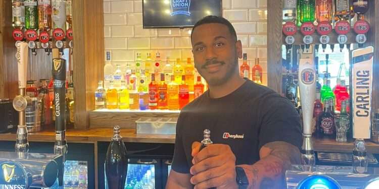 Johnathon Robinson behind the bar at the George Canning pub