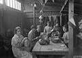 People making papier-mache heads for use in the trenches in WWI. Image: Imperial War Museum