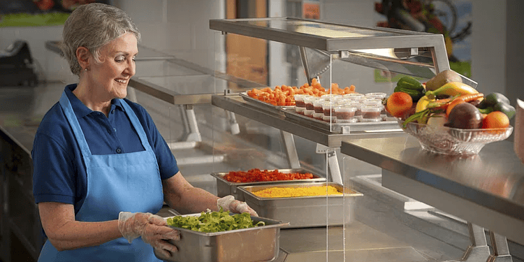 Stock image of dinner lady preparing school lunches. Credit: U.S Department of Agriculture (Creative Commons)