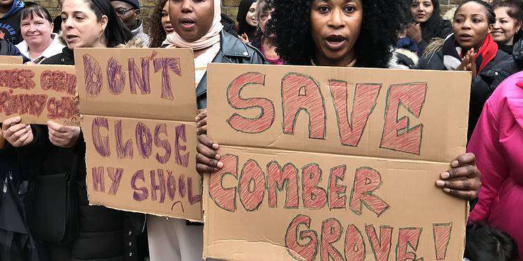 Parents gathered with placards outside Comber Grove Primary School