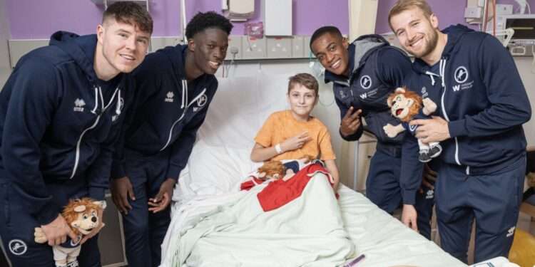 L-R Kevin Nisbet, Romain Esse, Aidomo Emakhu, Billy Mitchell, with patient Colin Travers on children's ward UHL.