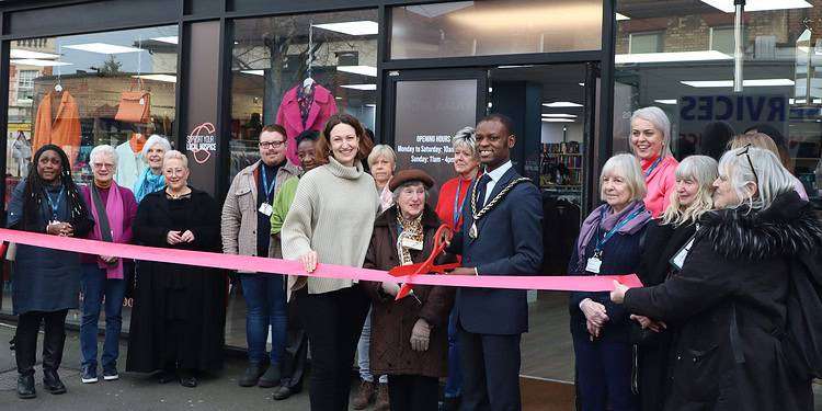 89-year-old Carolina cuts the ribbon at the East Dulwich store alongside Southwark Mayor Michael Situ