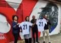 Eze's mum, dad and family members proudly stand by their son's mural. (credit: Kirby Estate)